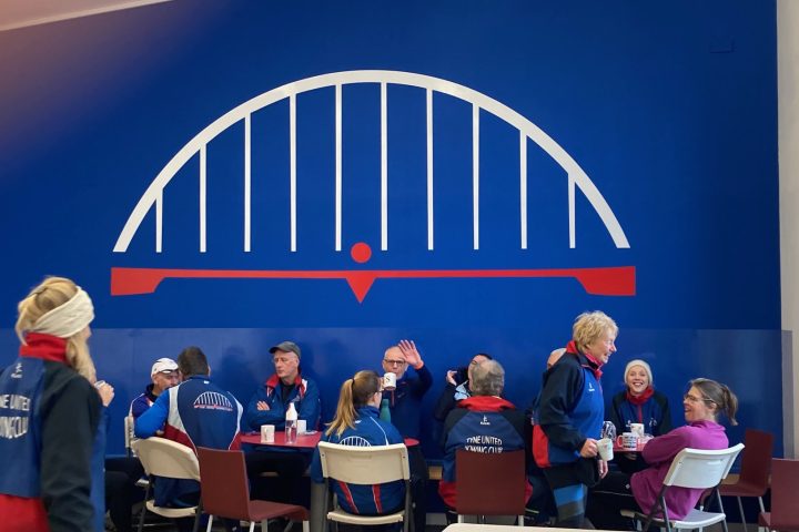 People having coffee at a rowing club.
