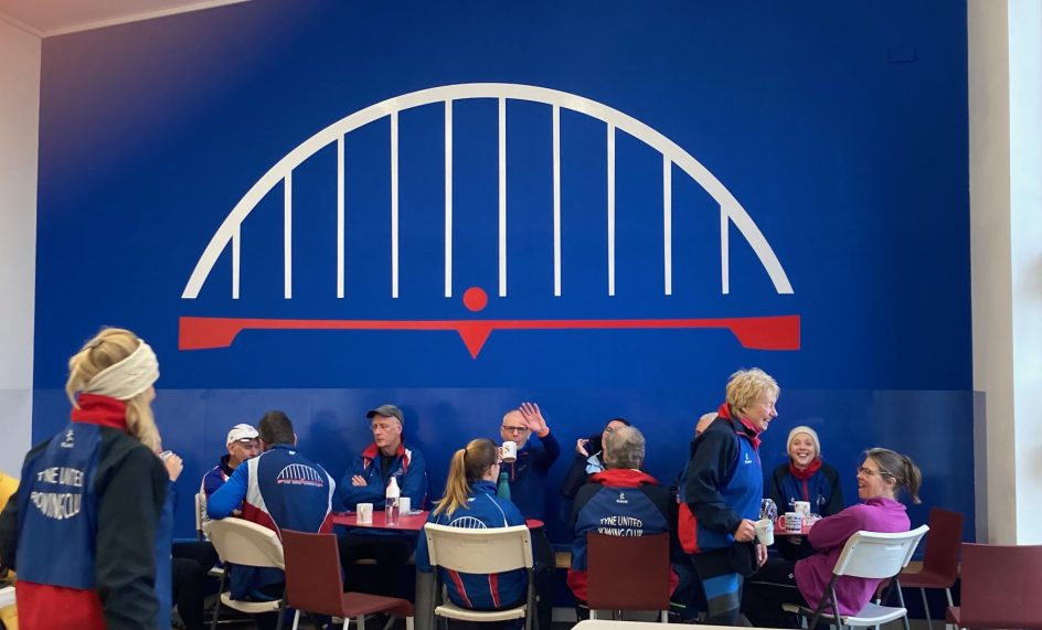 People having coffee at a rowing club.
